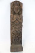 A 19th century oak carved cobel. Modelled as a 'caryatid' woman in a mask, 45.