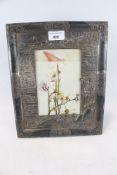 A Japanese silver plate cast and embossed easel frame.
