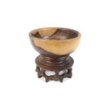 A late 20th century Chinese turned rosewood fruit bowl on carved and fretted circular stand. 23.