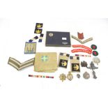 Military : A quantity of WWI and WWII insignia and cap badges etc.