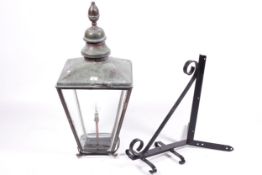 Copper topped Victorian street lamp with a corner wall mounting bracket.