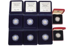 A group of eight silver proof coins.