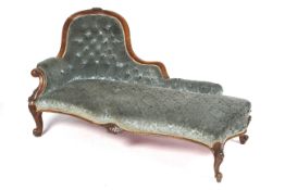 A Victorian walnut serpentine chaise lounge.