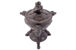 A 19th century Regency bronze three legged and lidded pot pourri pot.