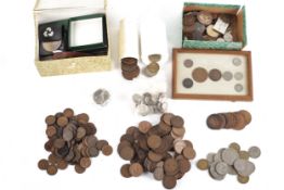 A metal box of of coins with silver 3 pences and 20th century farthings, further coins and badges.
