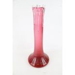 A cranberry glass vase.