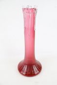 A cranberry glass vase.