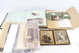 A collection of assorted vintage photographs and albums.