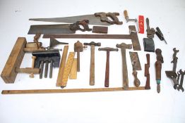 An assortment of vintage tools. Including saws, a ruler, clamps, a pen knife, etc.