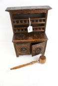 A miniature wooden dresser and a wooden gavel.