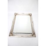 A contemporary bevelled edge mirror. With a silver painted frame, in the antique style, L61cm x H91.