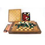 A collection of various chess sets, dominoes and snooker balls.