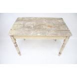 A vintage painted pine kitchen table.