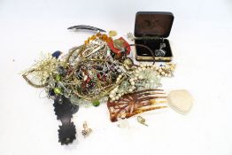 An assortment of costume jewellery. Including necklaces, pendants, strings of beads, etc.