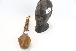 An African tribal head carving and a small club,