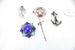 Five Scottish silver and white metal brooches.