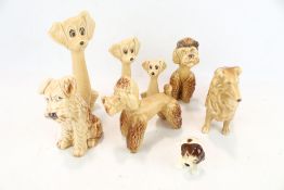 A collection of eight assorted vintage Sylvac pottery dogs. Including a pair of poodles, etc. Max.