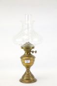 A late 19th Century brass bodied pedestal oil lamp with twin Duplex burners and clear,