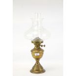 A late 19th Century brass bodied pedestal oil lamp with twin Duplex burners and clear,