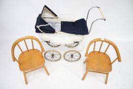 A Tri-ang pram and two childrens' wooden chairs.