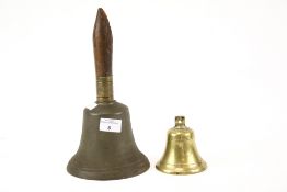 Two vintage bells. Including a 'school' hand bell stamped 'R.WELLS' on the interior, H28.