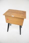 A 1960s sewing work box on black legs.