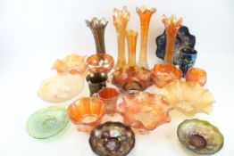 A collection of vintage carnival glass. Including bowls, vases and a jug, etc.