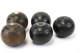 A collection of five vintage lawn bowls.