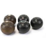 A collection of five vintage lawn bowls.