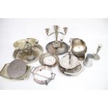 A collection of assorted vintage silver plated items. Including a round tray, candlesticks, etc.