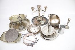 A collection of assorted vintage silver plated items. Including a round tray, candlesticks, etc.