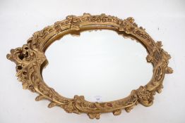 A gilt framed wall mirror.
