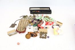 An assortment of costume jewellery. Including necklaces, hairpieces, a purse, locket, etc.