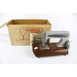 A vintage Grain toy hand crank sewing machine, boxed.