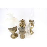 A group of four brass oil lamps. Including a Hinks Benetfink No. 2 Duplex, etc. Max.