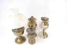 A group of four brass oil lamps. Including a Hinks Benetfink No. 2 Duplex, etc. Max.