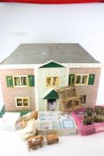 A vintage dolls house and a collection of accessories.