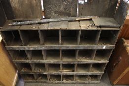 An old wooden multi pigeon holes storage unit.