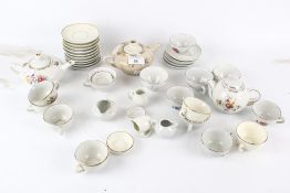 A collection of vintage toy miniature tea services. Including three tea pots, cups and saucers, etc.