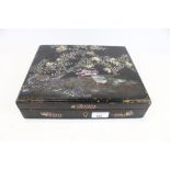 A Japanese mother of pearl inlaid lacquer box.