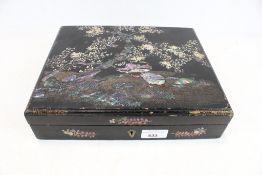 A Japanese mother of pearl inlaid lacquer box.