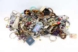 An assortment of costume jewellery. Including bangles, necklaces, brooches, beads, etc.