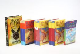 A collection of five assorted Harry Potter books.