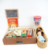 An assortment of vintage toys. Including a model fort, books, a blackboard, a doll, etc.