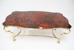 A contemporary faux tortoise shell top brass framed coffee table.