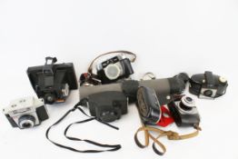 A group of assorted vintage film cameras. Including Polaroid, etc.