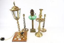 A selection of 19th century and later lamps and candlesticks.