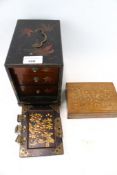 A Japanese lacquer jewellery box with a door enclosing three drawers,