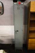 An old grey metal Police locker and key. L30cm x D46cm x H182.