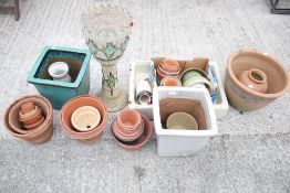 A collection of garden pots, a jardiniere and stand and a Belfast sink.